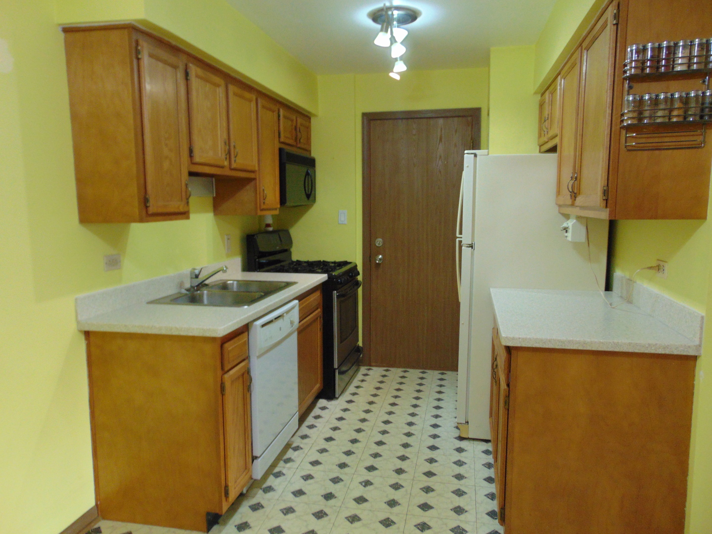 10428 Ridgeland Avenue, Unit 6 Chicago Ridge, IL 60415 - Photo 5 of 11 a kitchen with a sink a refrigerator and cabinets