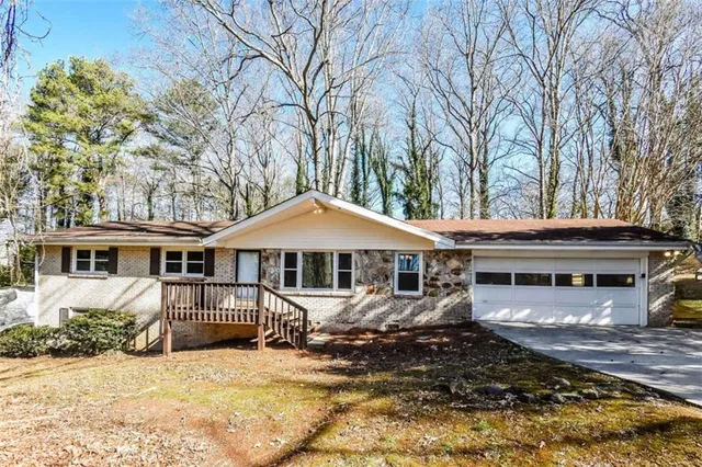a front view of a house with a yard covered with snow in front of house