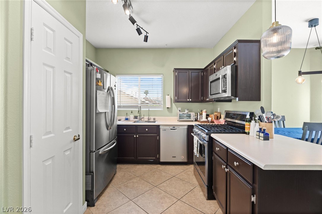 3238 Mystic Ridge Court Las Vegas, NV 89129 - Photo 5 of 31 Culinary delights await in this modern kitchen with ample counter space and well-appointed appliances.