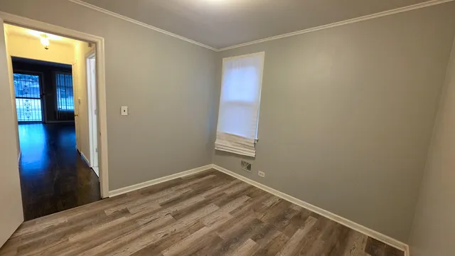 a view of a room with wooden floor