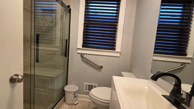 a bathroom with a toilet and a shower