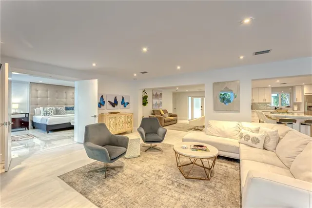 a large kitchen with kitchen island a stove a sink a dining table and chairs