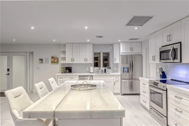 a view of a dining room with furniture and a chandelier