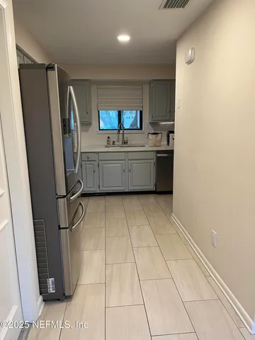 a kitchen with stainless steel appliances a refrigerator and a counter
