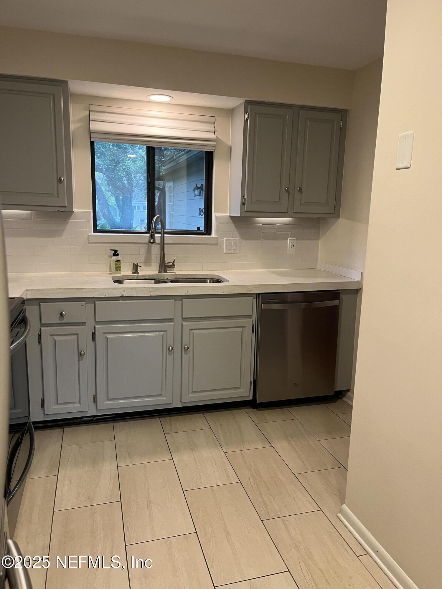 1809 Kings Way Neptune Beach, FL 32266 - Photo 15 of 28 a kitchen with stainless steel appliances a sink stove and cabinets