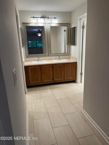 a bathroom with a sink a mirror and cabinets
