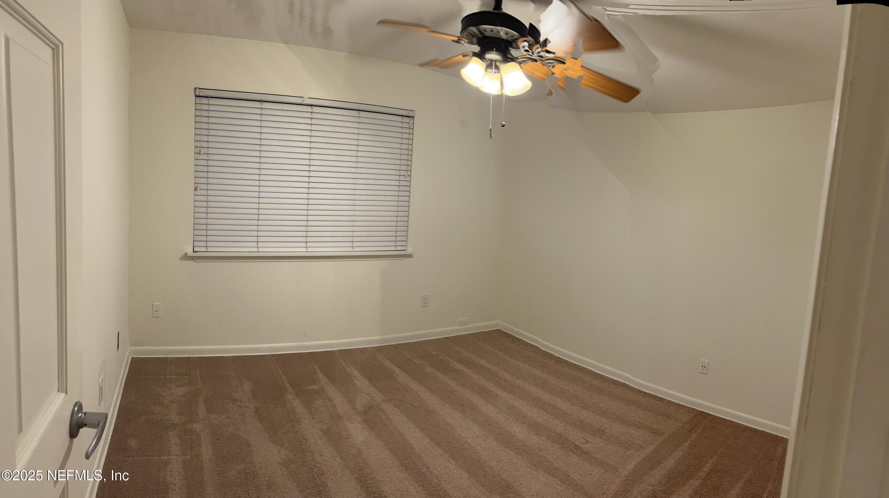 1809 Kings Way Neptune Beach, FL 32266 - Photo 19 of 28 an empty room with a window and a fan