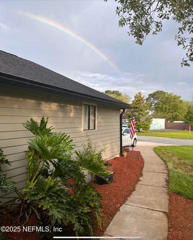 a front view of a house with a yard and mountain view