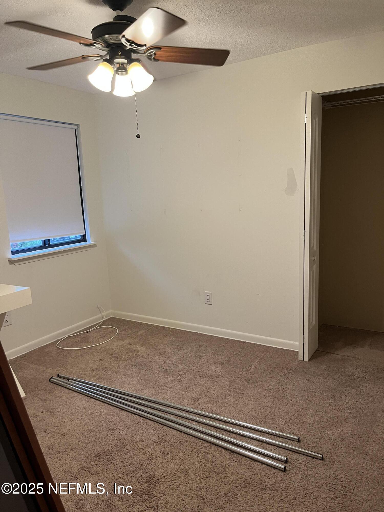 1809 Kings Way Neptune Beach, FL 32266 - Photo 24 of 28 a view of a room with wooden floor and a ceiling fan