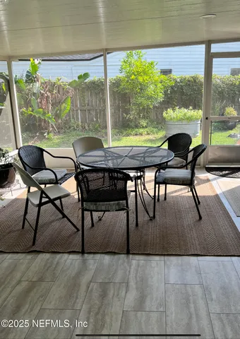 a dining room with furniture and wooden floor
