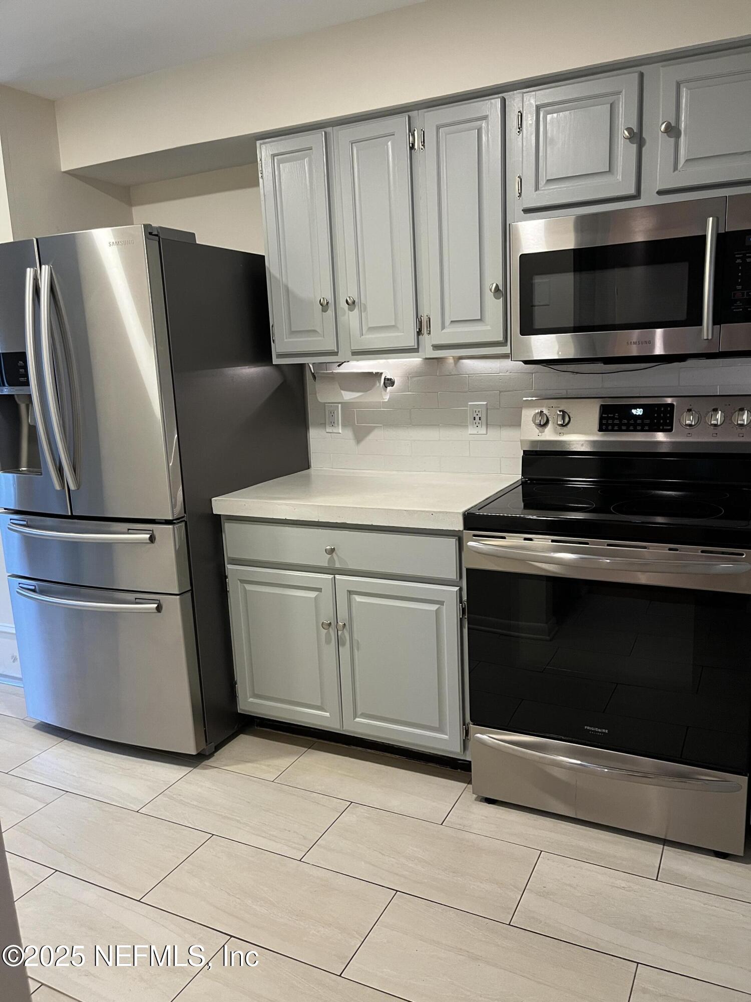 1809 Kings Way Neptune Beach, FL 32266 - Photo 8 of 28 a kitchen with cabinets and steel stainless steel appliances