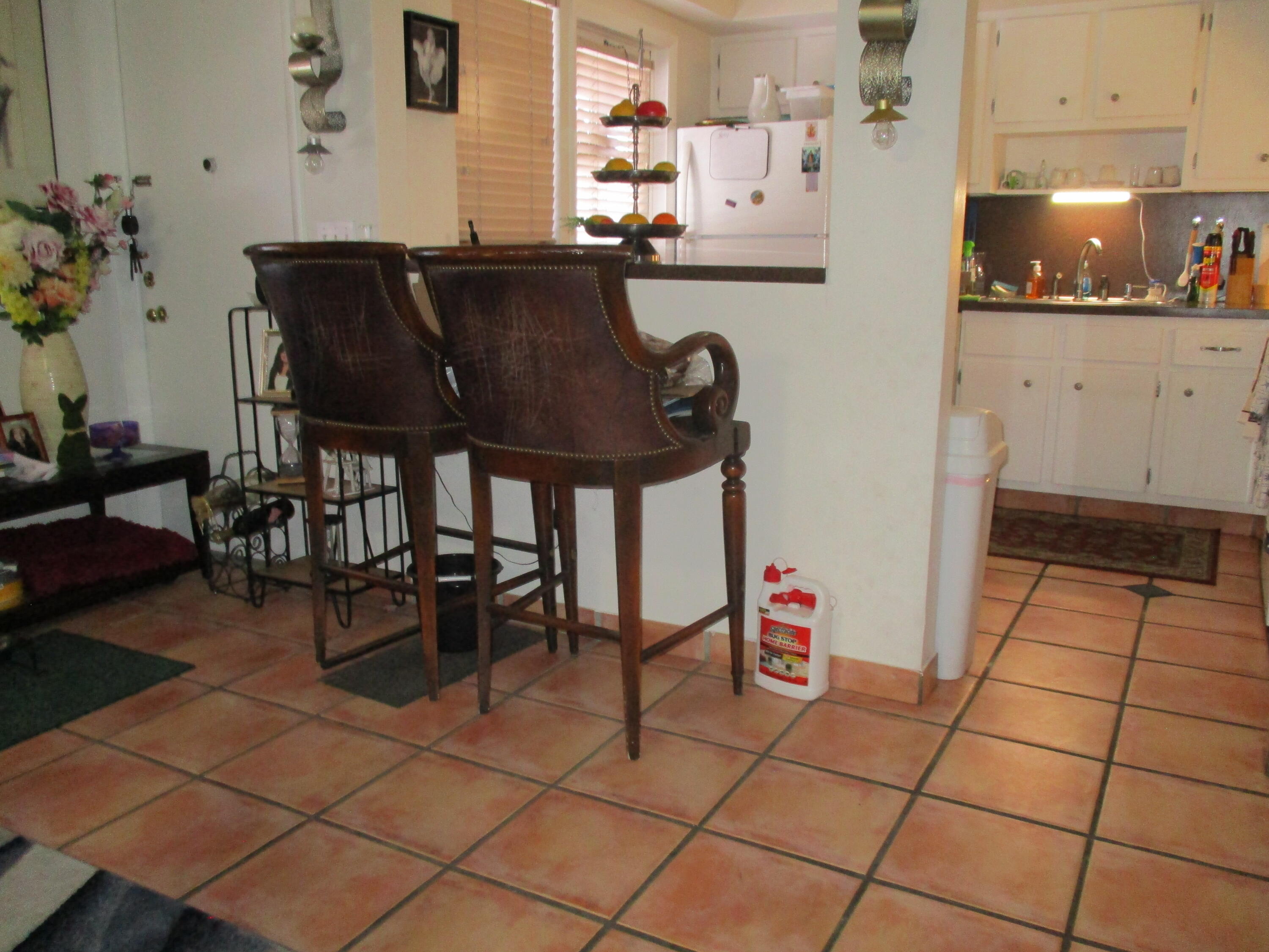 3720 Harrison Street, Unit 3 Hollywood, FL 33021 - Photo 5 of 8 a kitchen with a sink a table and chairs in it