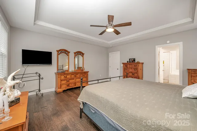 a bedroom with a bed and flat screen tv