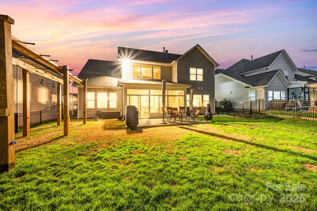 a view of residential houses with yard and swimming pool