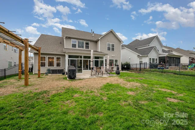 a view of an house with backyard space and balcony