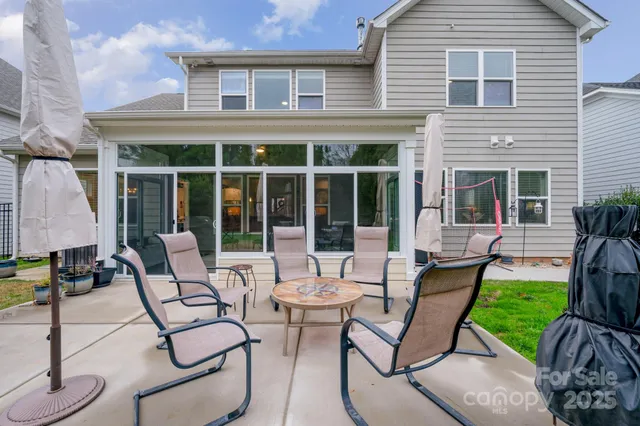 a view of a house with backyard sitting area and garden