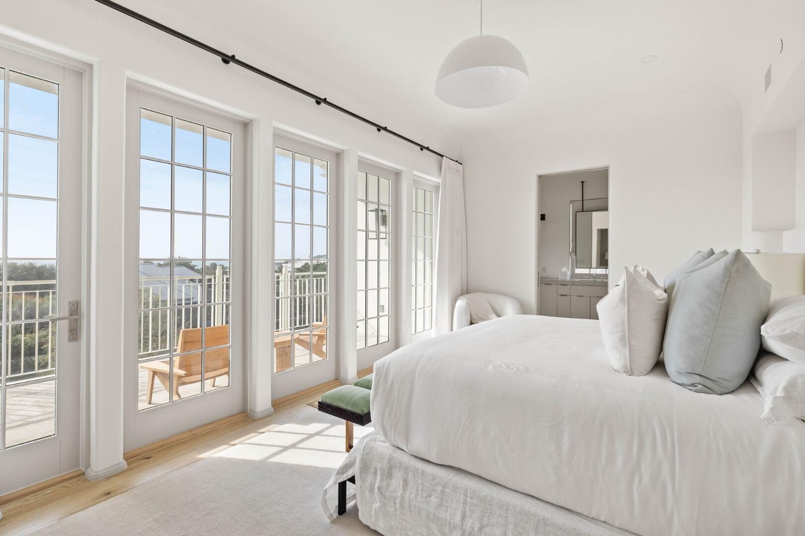 45 West Solaire Way Inlet Beach, Unit 308 Inlet Beach, FL 32461 - Photo 2 of 10 a bedroom with a large bed and a large window with outer view