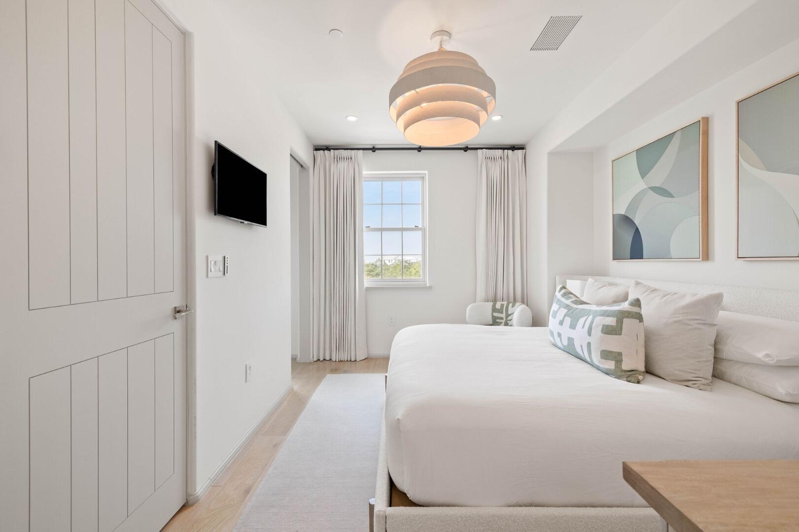 45 West Solaire Way Inlet Beach, Unit 308 Inlet Beach, FL 32461 - Photo 3 of 10 a bedroom with a bed and a flat screen tv