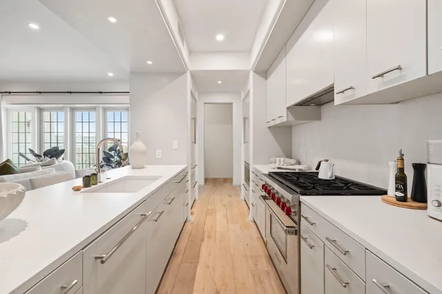 a kitchen with a sink stove and cabinets