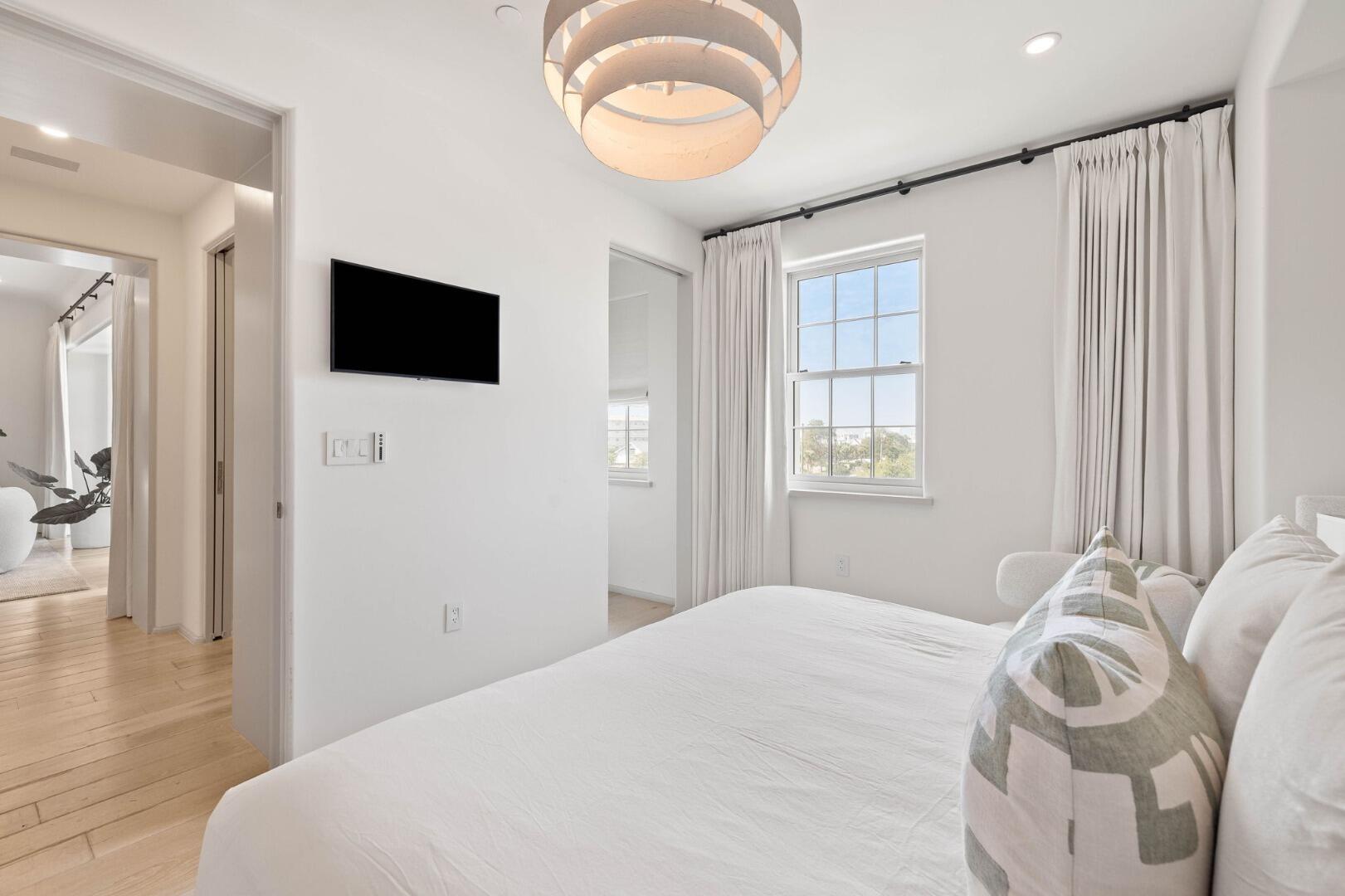 45 West Solaire Way Inlet Beach, Unit 308 Inlet Beach, FL 32461 - Photo 10 of 10 a bedroom with a large bed and a tv