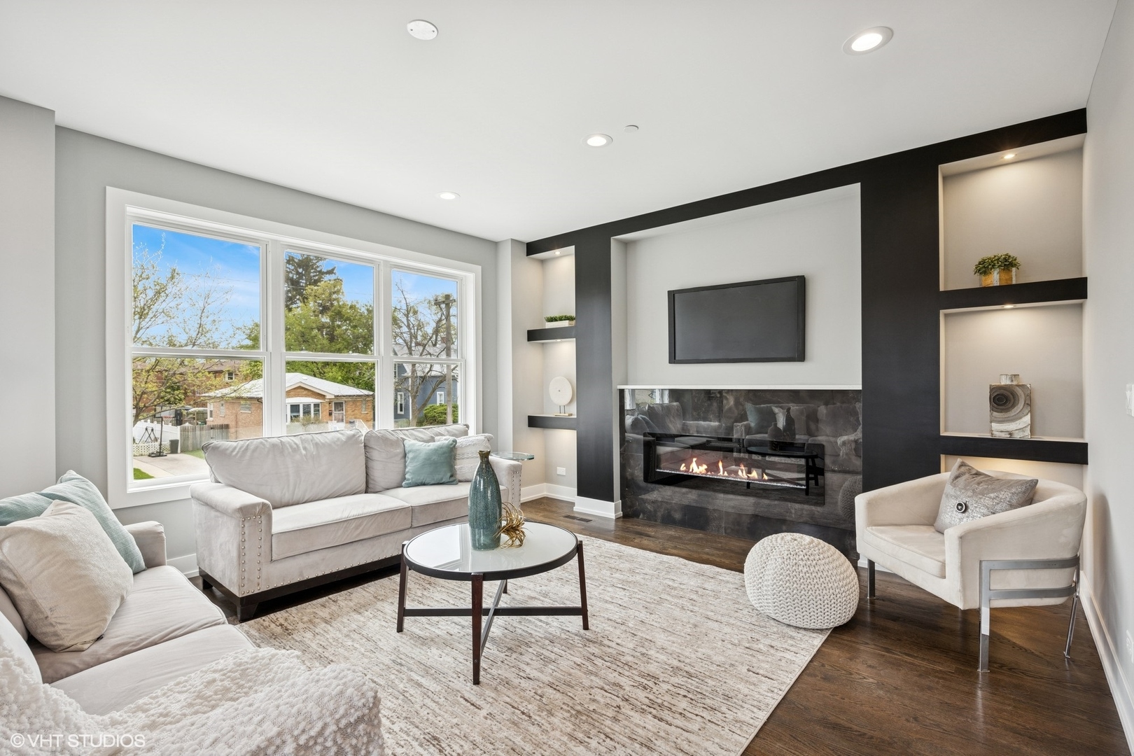 8524 Center Avenue River Grove, IL 60171 - Photo 12 of 38 a living room with furniture a fireplace and a flat screen tv