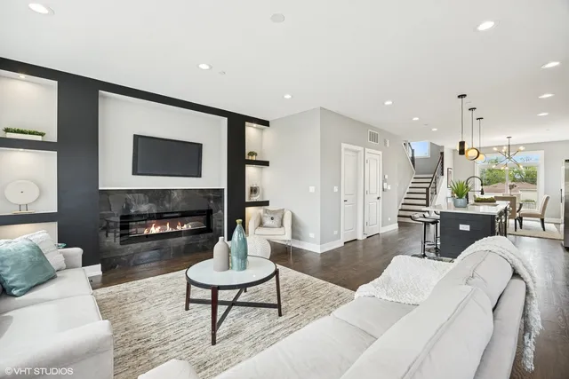 a living room with fireplace furniture and a flat screen tv