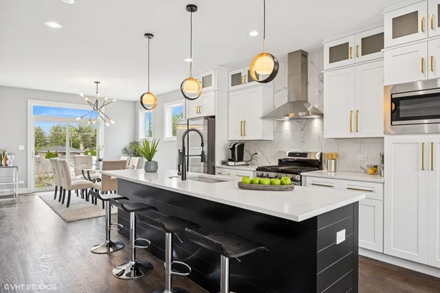 a kitchen with a sink a stove and chairs