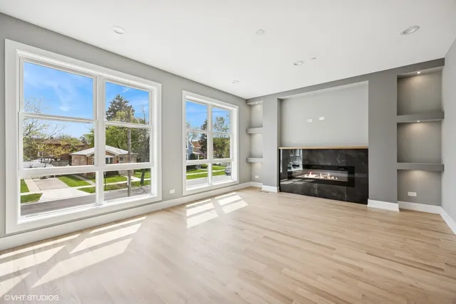 a view of livingroom with furniture flat screen tv and floor to ceiling window