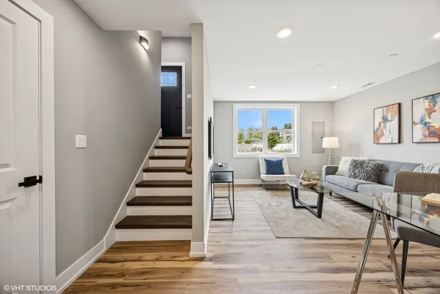 a living room with furniture and entryway
