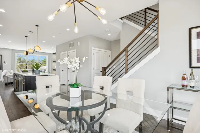 a dining room with furniture and a chandelier