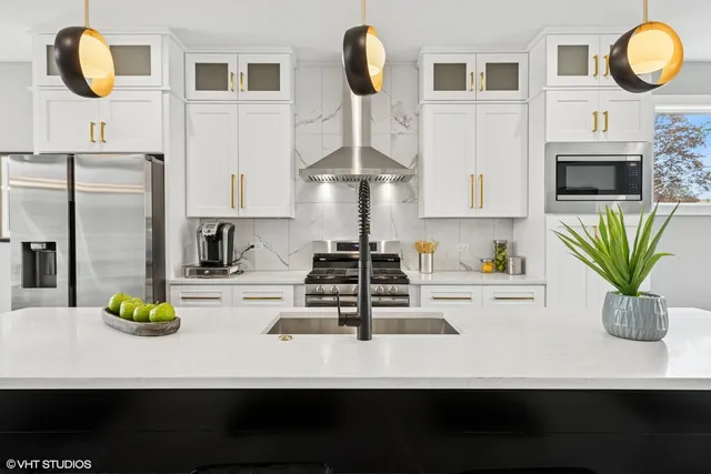 a kitchen with a refrigerator and a white cabinets