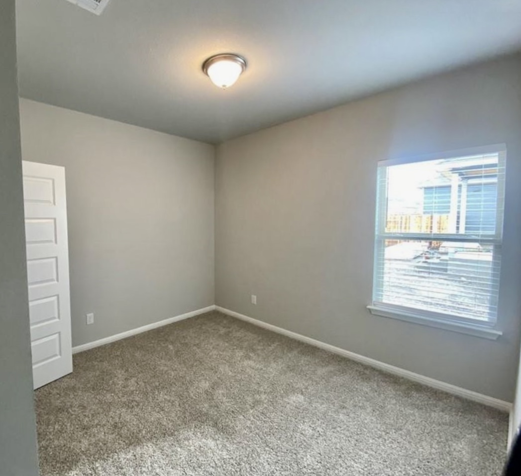 119 Wild Wind Cove Jarrell, TX 76537 - Photo 12 of 16 Carpeted empty room featuring baseboards