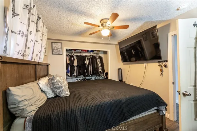 a bedroom with a bed and a television