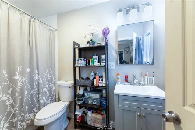 a bathroom with a sink a toilet and a mirror