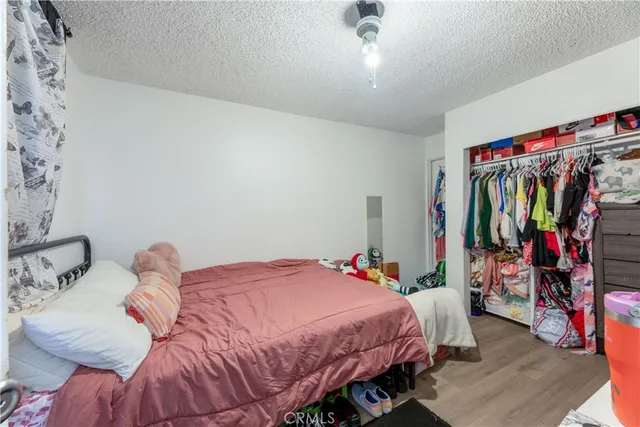 a bedroom with a bed and a closet