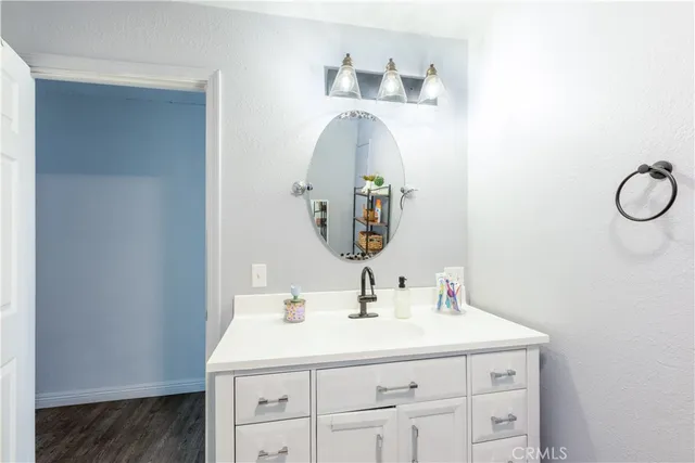 a bathroom with a sink vanity and a mirror