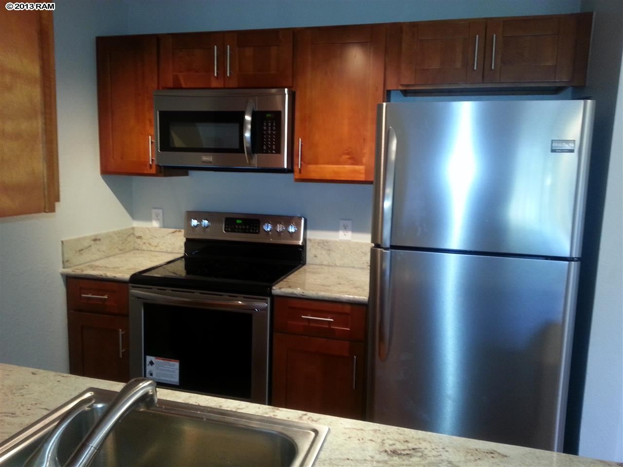 a kitchen with a refrigerator and a microwave