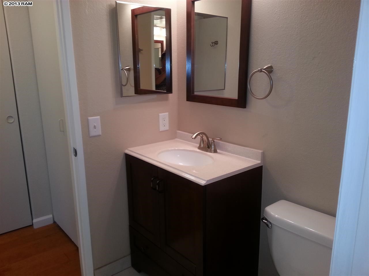 140 Uwapo Road, Unit 9104 Kihei, HI 96753 - Photo 15 of 27 a bathroom with a toilet sink and mirror