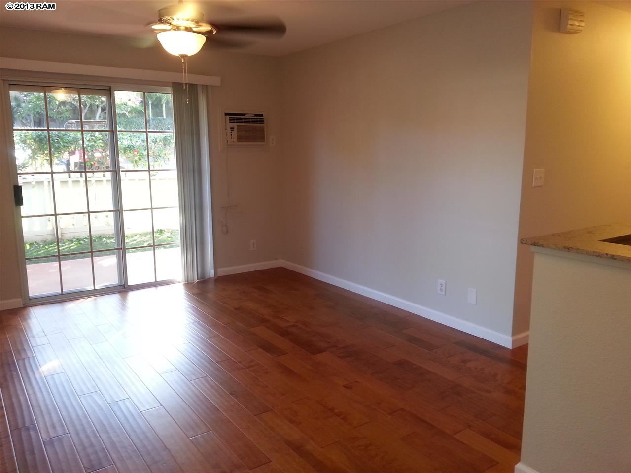 140 Uwapo Road, Unit 9104 Kihei, HI 96753 - Photo 2 of 27 an empty room with wooden floor and windows