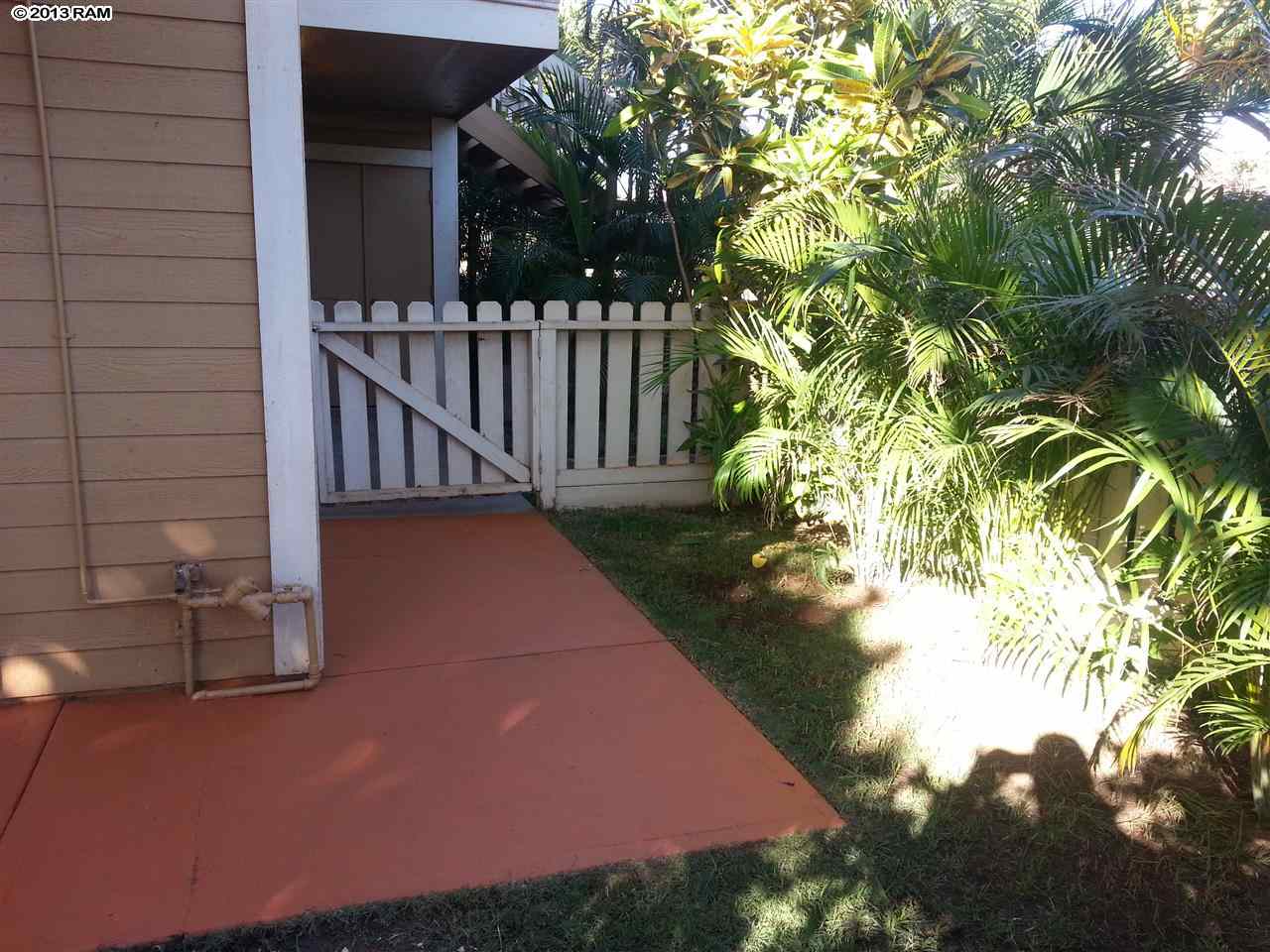 140 Uwapo Road, Unit 9104 Kihei, HI 96753 - Photo 24 of 27 a view of a yard with plants and wooden fence