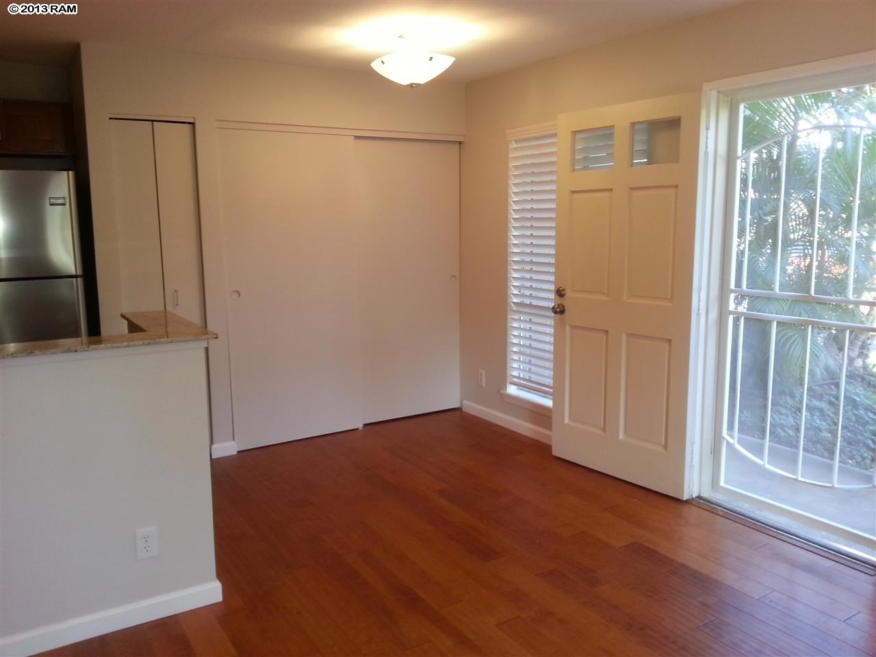 140 Uwapo Road, Unit 9104 Kihei, HI 96753 - Photo 3 of 27 an empty room with wooden floor and windows