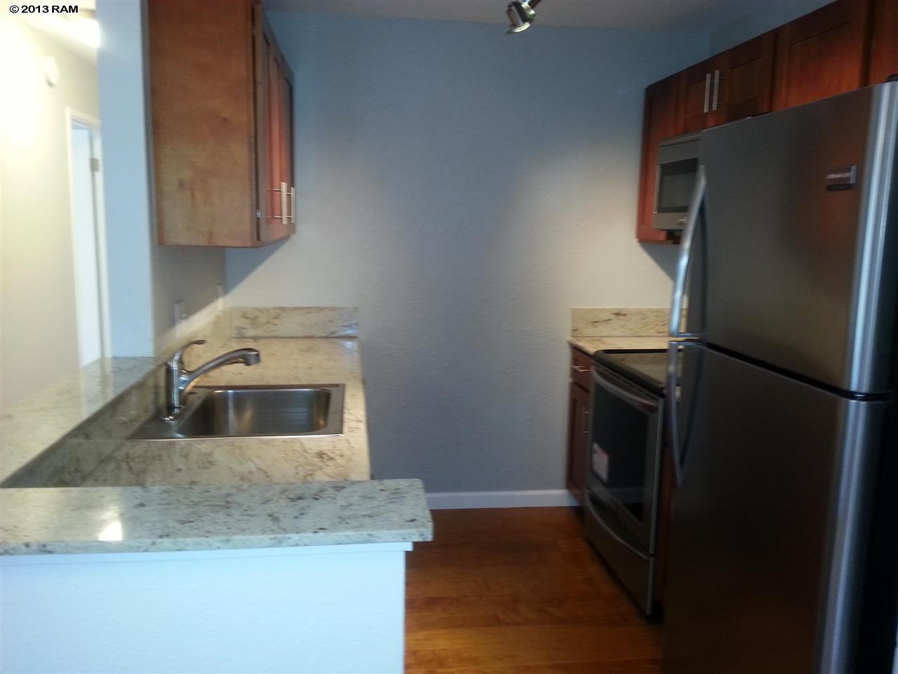 140 Uwapo Road, Unit 9104 Kihei, HI 96753 - Photo 4 of 27 a kitchen with a refrigerator sink and stove