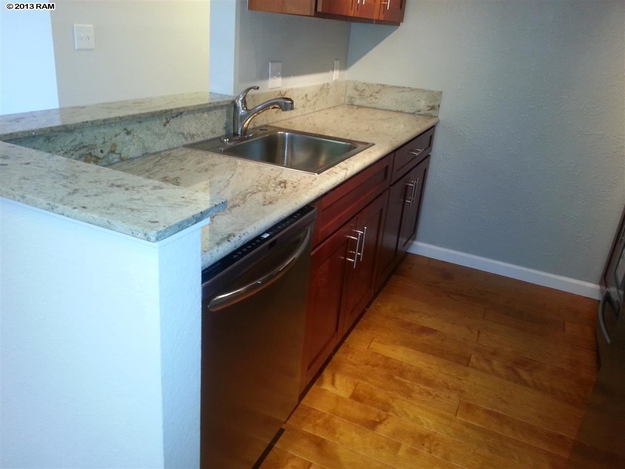 140 Uwapo Road, Unit 9104 Kihei, HI 96753 - Photo 5 of 27 a kitchen with a sink and cabinets