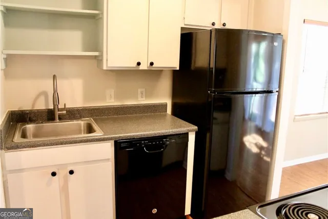 a kitchen with a sink and a refrigerator