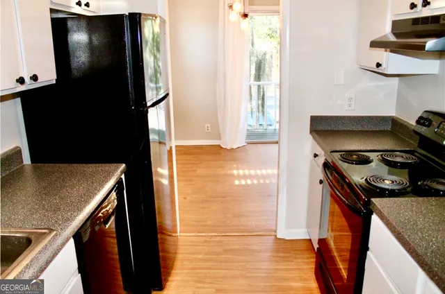 a kitchen with a stove and a refrigerator