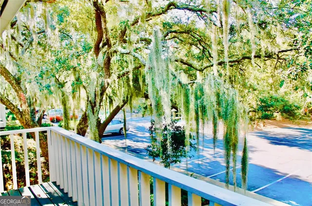 a view of a wooden fence and trees