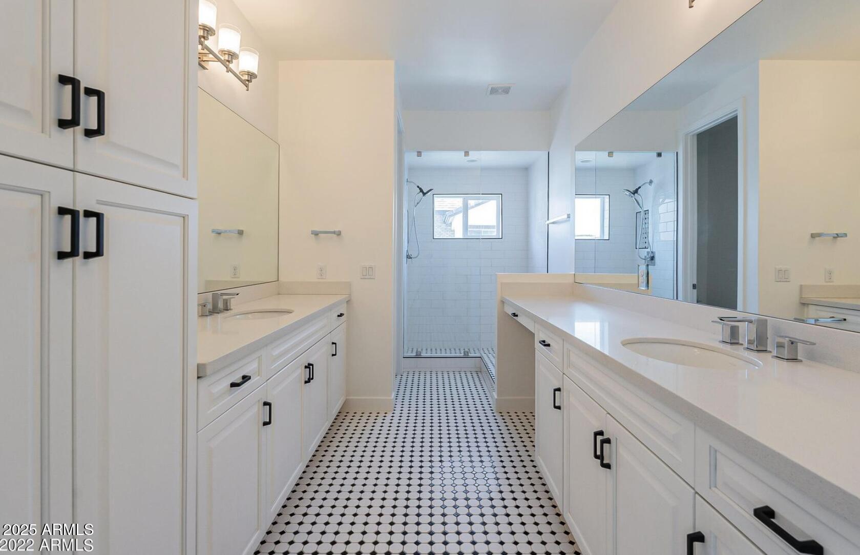 3030 North 38th Street, Unit 113 Phoenix, AZ 85018 - Photo 15 of 22 a spacious bathroom with a double vanity sink a mirror and a shower