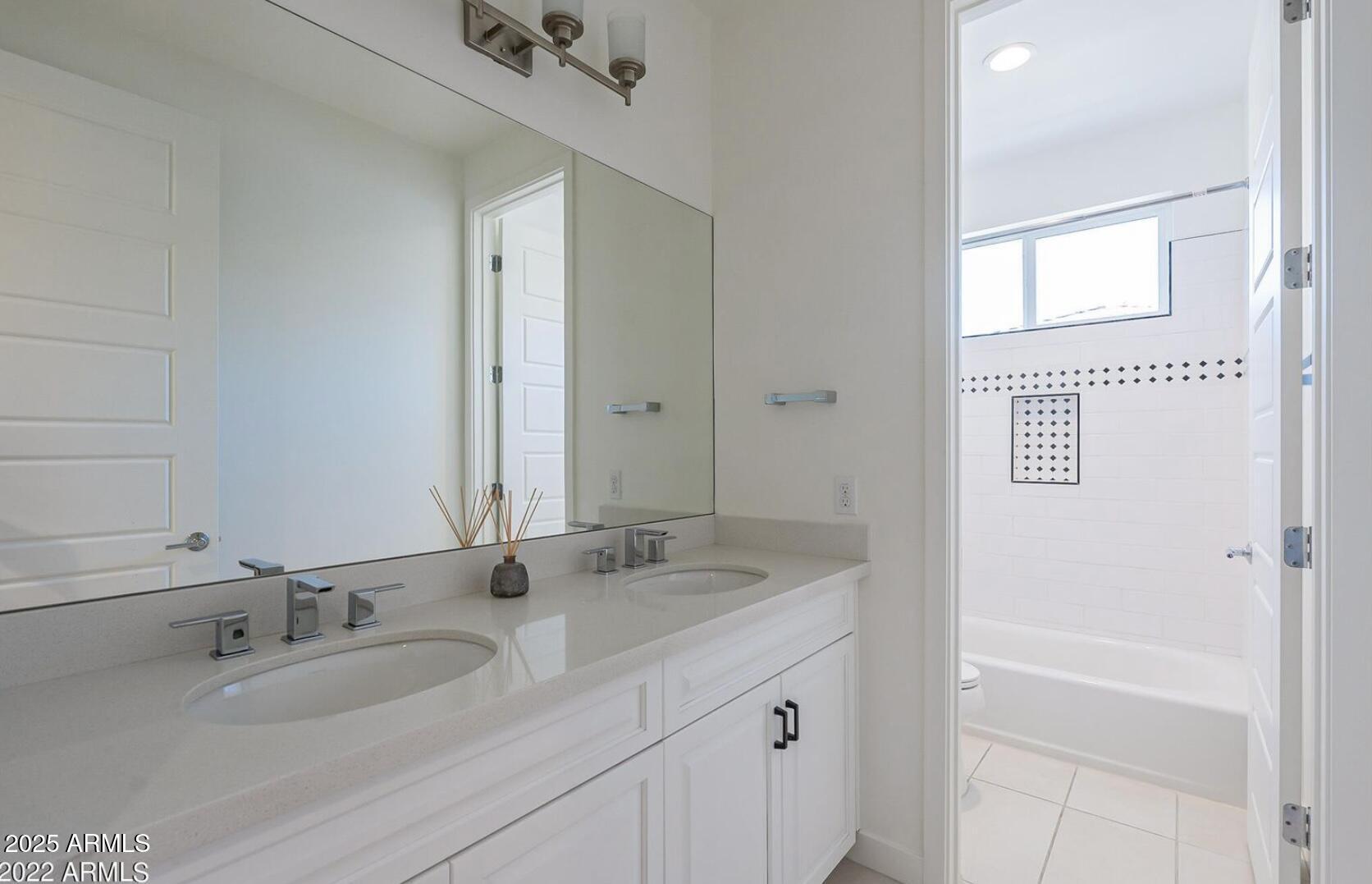 3030 North 38th Street, Unit 113 Phoenix, AZ 85018 - Photo 19 of 22 a bathroom with a granite countertop sink and a mirror