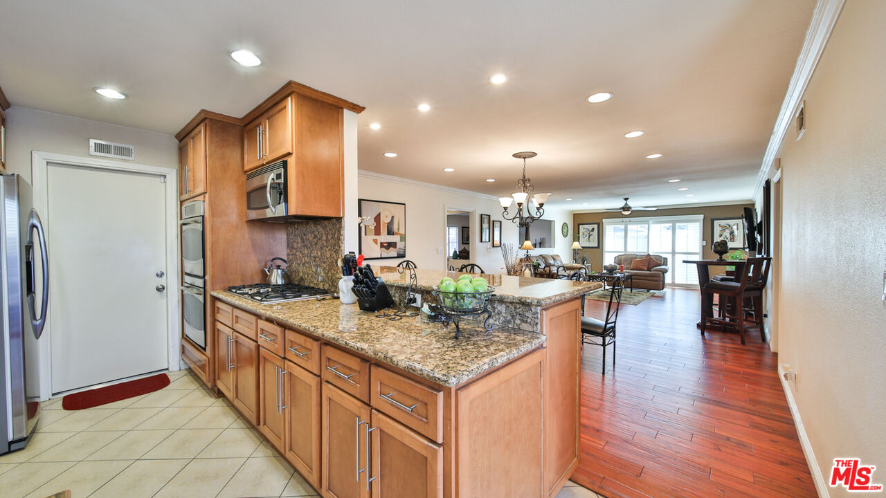 16953 Roa Drive Carson, CA 90746 - Photo 21 of 48 a kitchen with counter top space and wooden floor