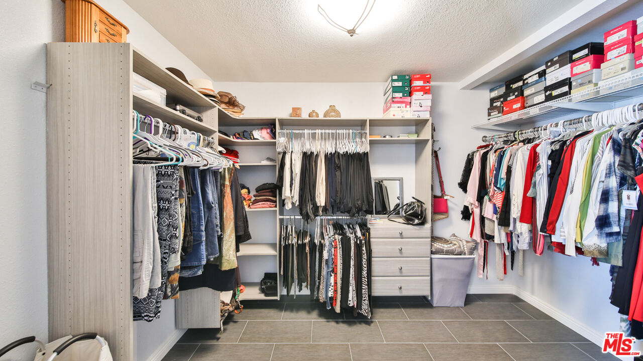 16953 Roa Drive Carson, CA 90746 - Photo 36 of 48 a view of walk in closet with clothes and shoes